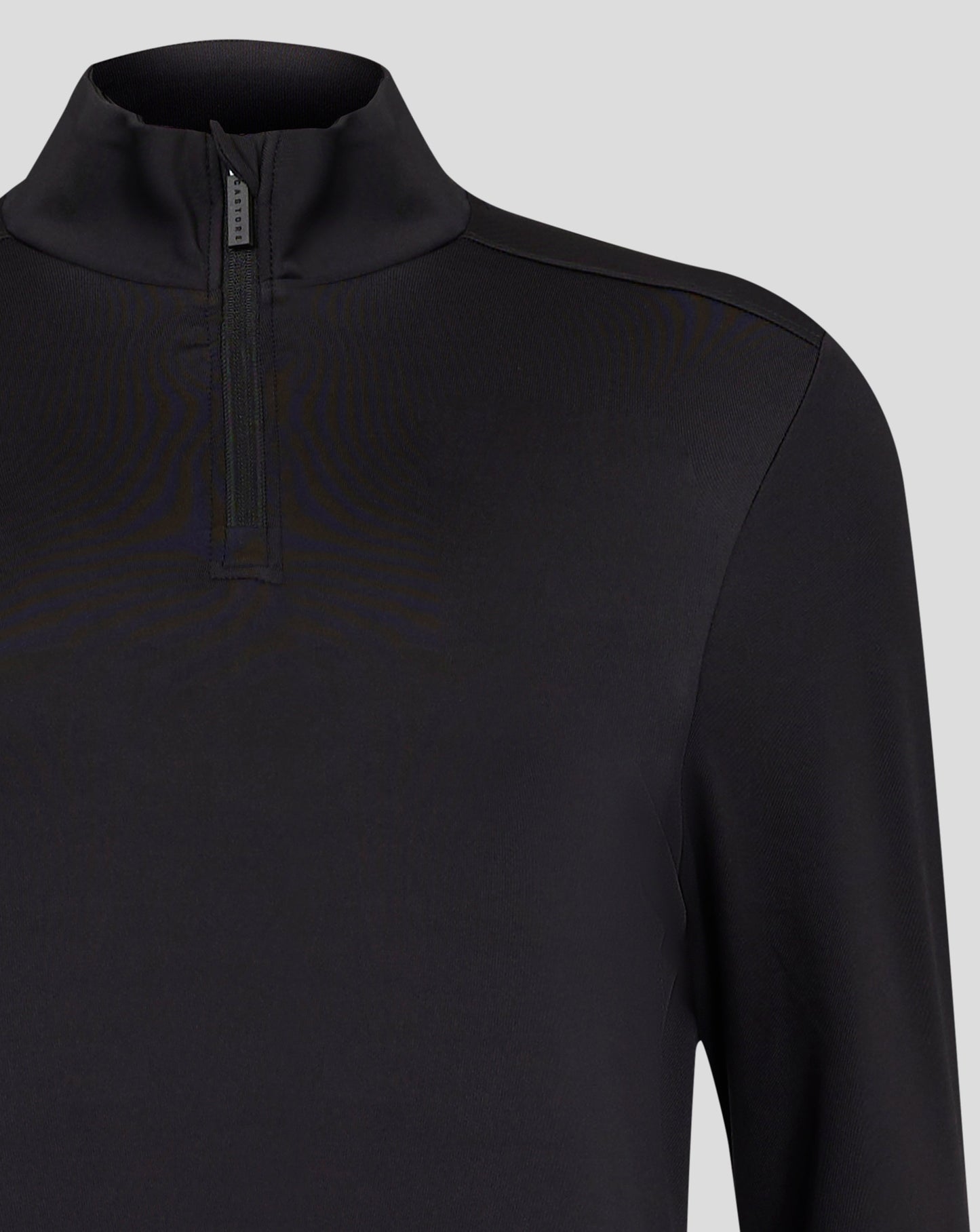 Close up of black Caviar Womens 1/4 zip showing chin guard at the zip and Castore zipper pull