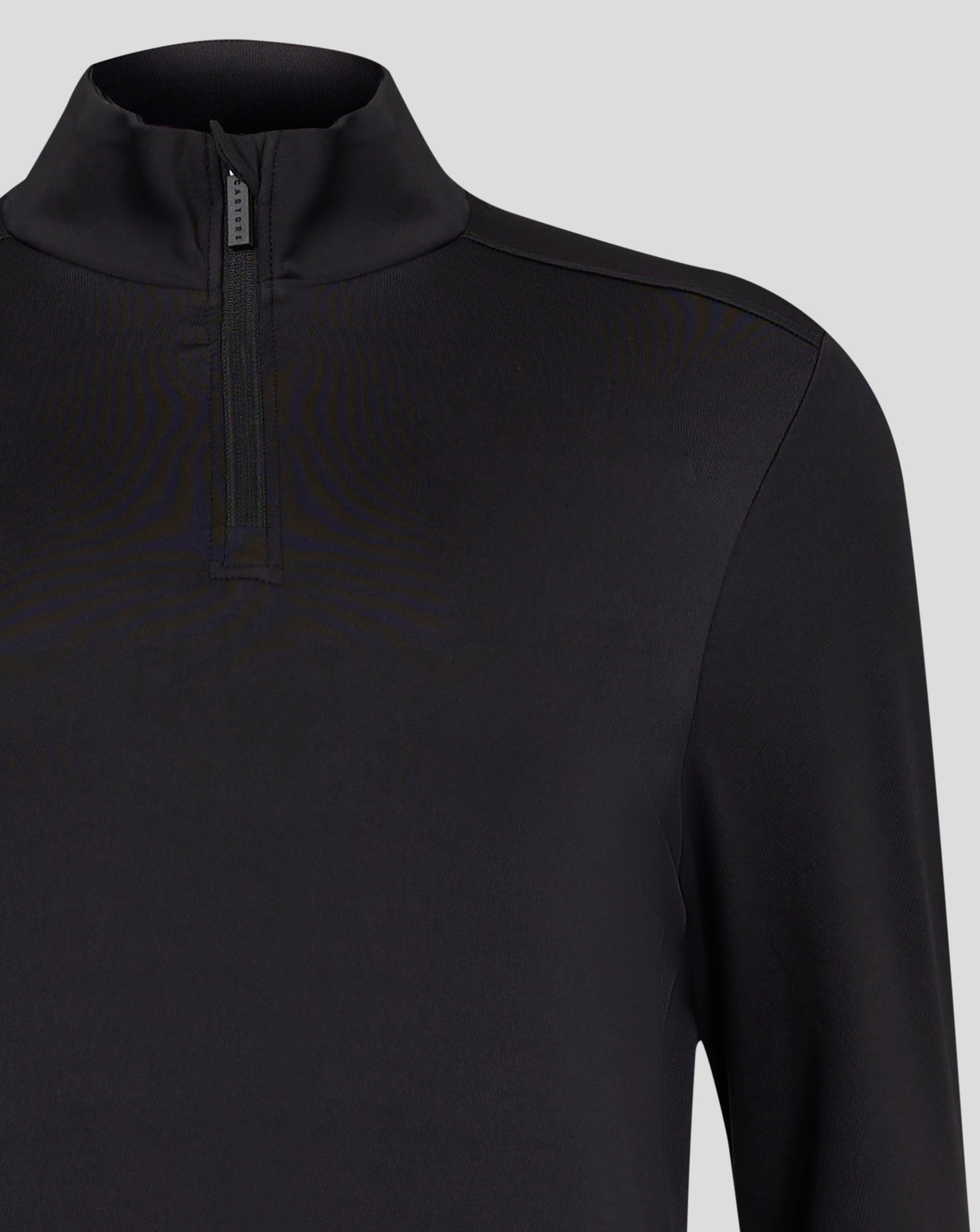 Close up of black Caviar Womens 1/4 zip showing chin guard at the zip and Castore zipper pull