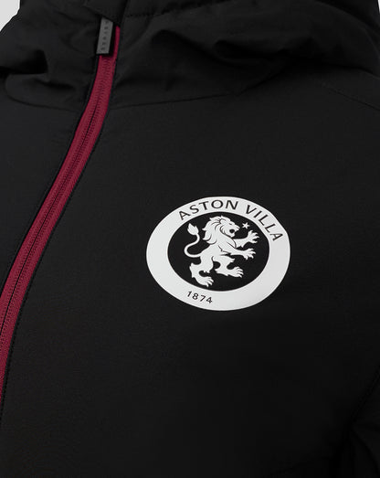 Circular white Aston Villa crest badge on the black jacket with a pink zipper nearby