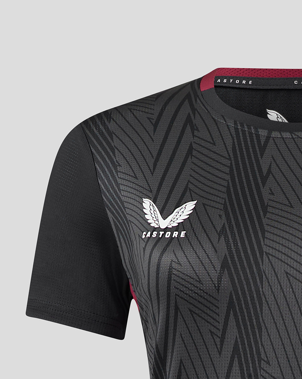 Close up of a black and charcoal geometric patterned women's Aston Villa staff training general short sleeve shirt with the club crest on the chest.