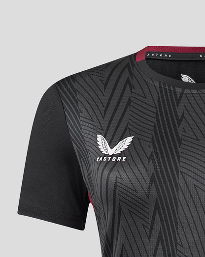 Close up of a black and charcoal geometric patterned women's Aston Villa staff training general short sleeve shirt with the club crest on the chest.