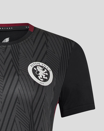 Shoulder and chest view of a dark grey patterned women's Aston Villa staff training general short sleeve shirt with the white club crest.
