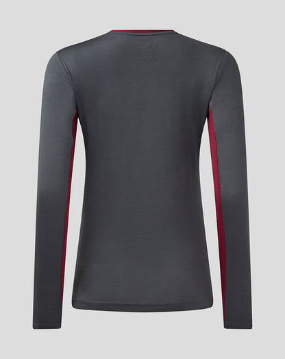 Back view of a women's Aston Villa Coaches Training long sleeve tee in ebony with rhododendron side panels