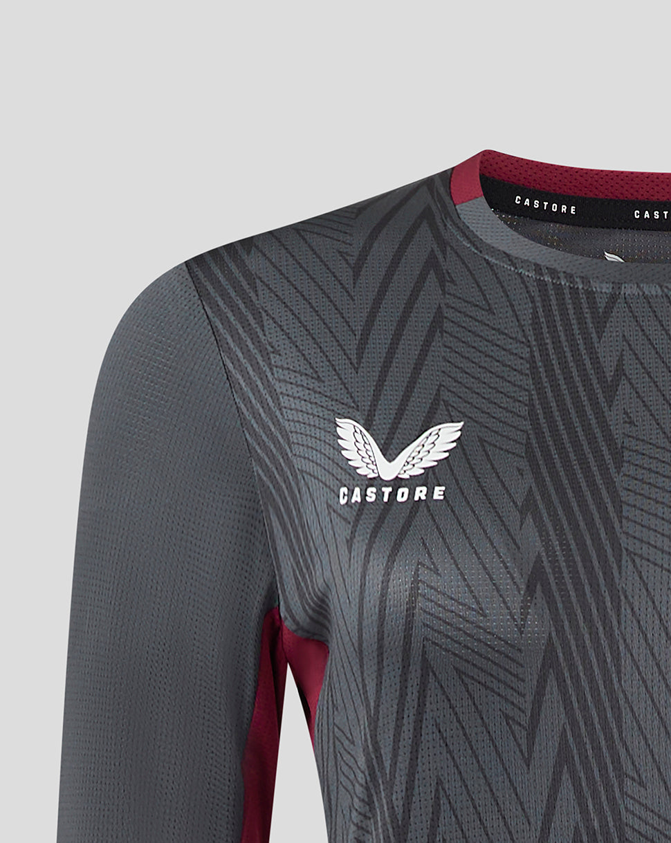 Close-up of chest on a dark grey Castore Villa training tee with geometric pattern and Aston Villa crest