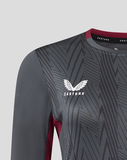 Close-up of chest on a dark grey Castore Villa training tee with geometric pattern and Aston Villa crest