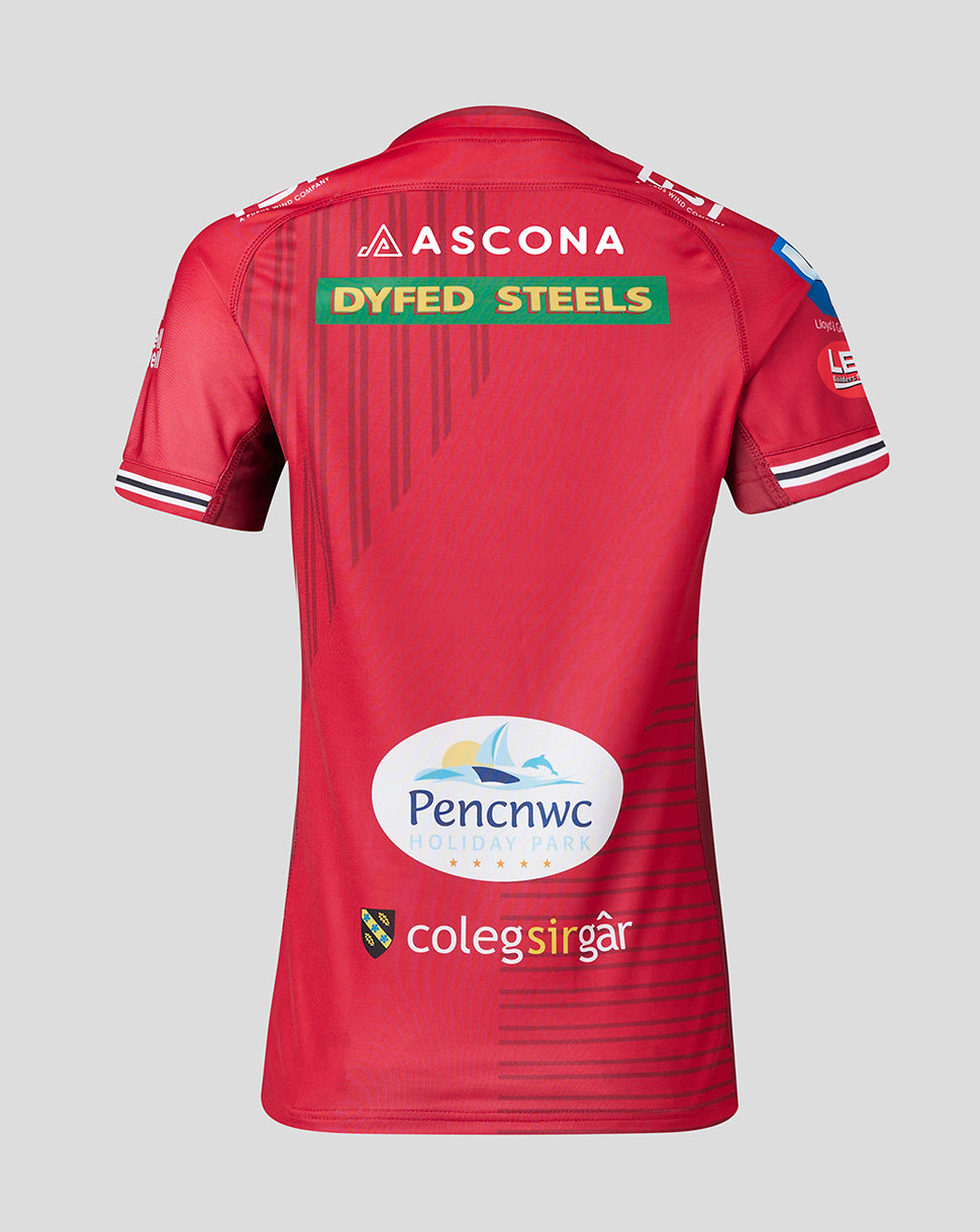 Back view of Scarlets Women’s 23/24 home shirt with ASCONA Dyfed Steels PenCnw Holiday Park and Coleg Sir Gar logos on red fabric