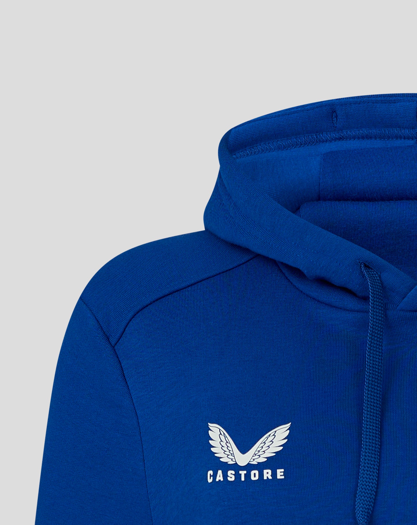 Close up of blue hoodie hood showing top seam and fabric texture.