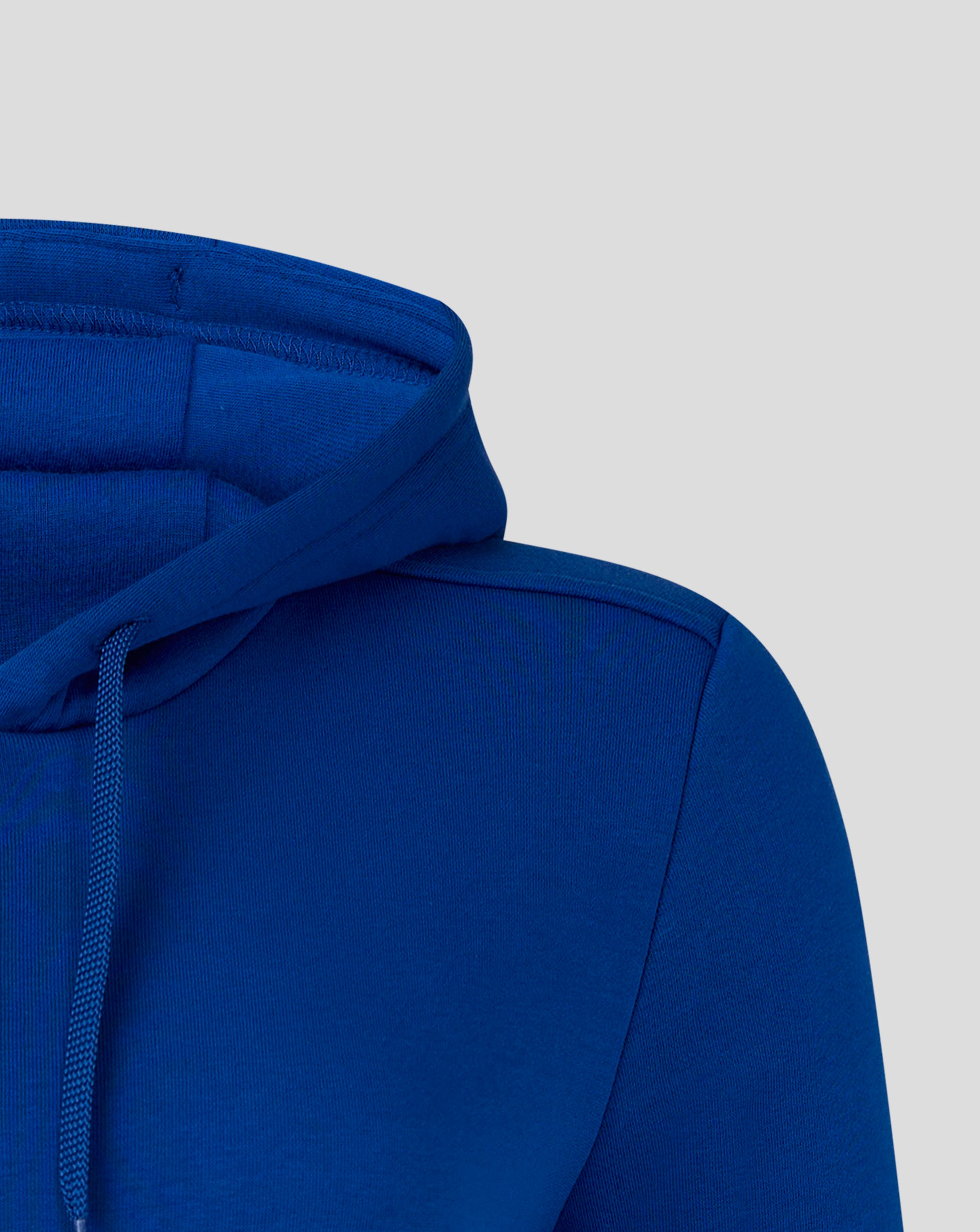 Blue hoodie with Castore logo and wings visible on chest.