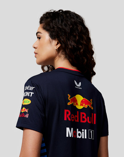 Back view of a woman in the Night Sky Teamline Set Up T Shirt with the 20th anniversary logo on the back and sponsor graphics