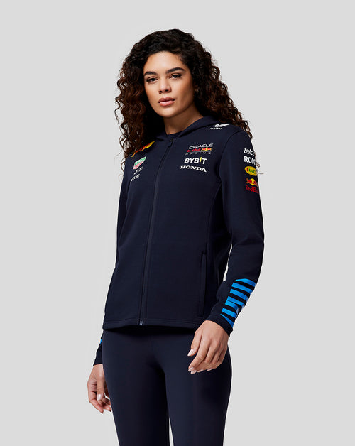 Woman wearing a navy full zip hoodie featuring Oracle Red Bull Racing logos and back graphic
