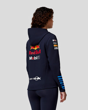 Rear view of a woman in a navy Red Bull Racing hoodie with a large Red Bull logo on the back and sponsor logos on the sleeve.