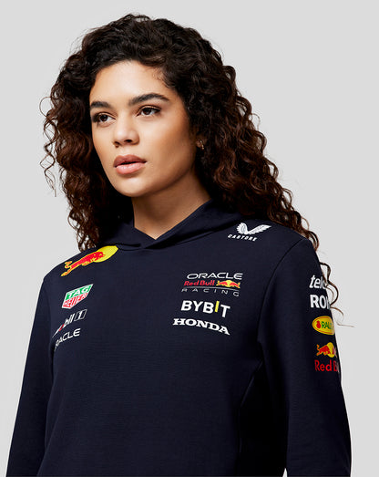 Woman wearing navy Oracle Red Bull Racing Teamline Hoodie Night Sky with multiple sponsor logos on chest and sleeve
