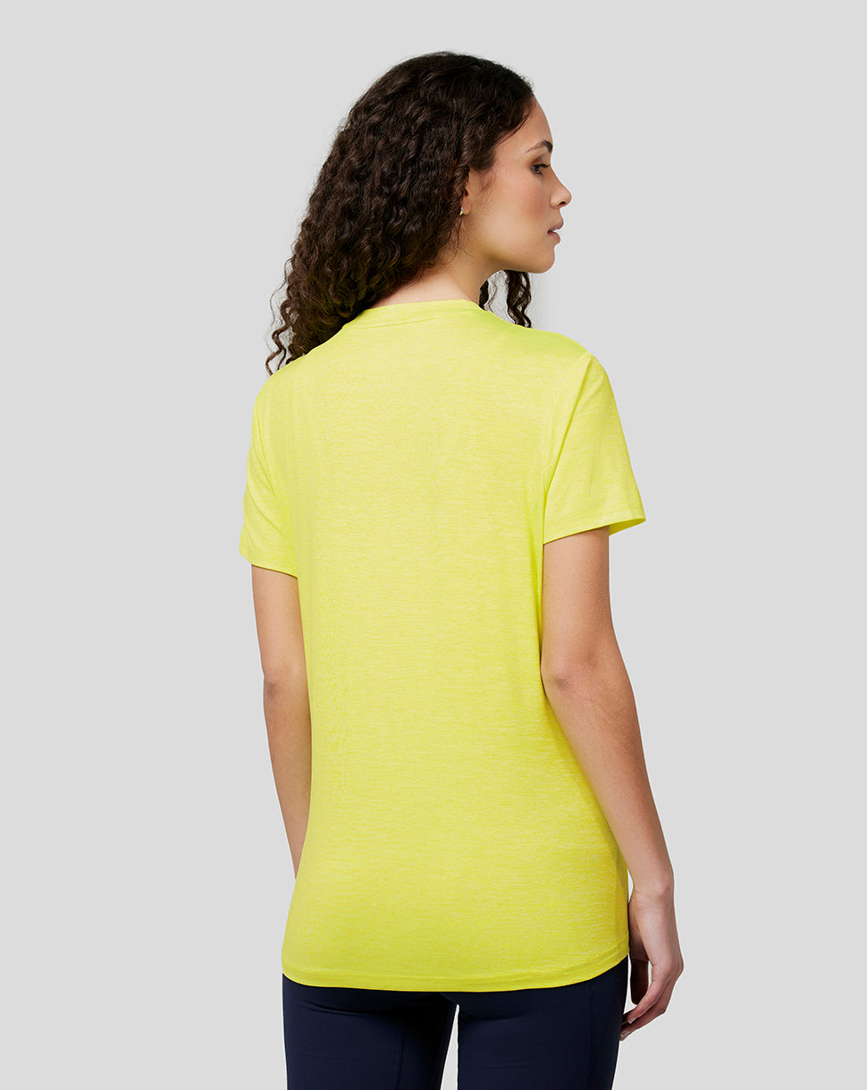 Back view of a woman wearing Safety Yellow Oracle Red Bull Racing women's active tee