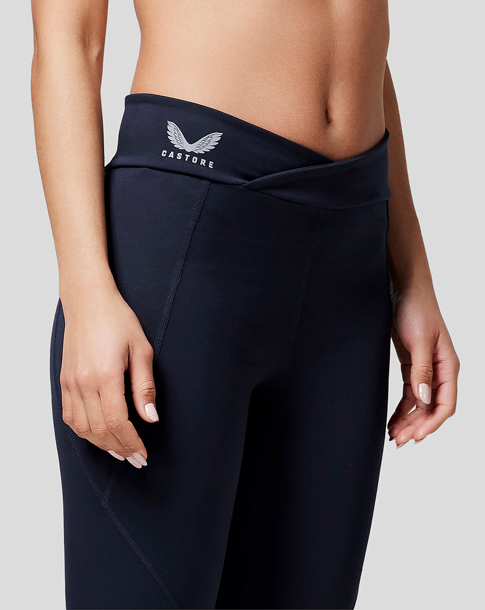 Close-up of navy leggings waist showing Castore branding on the waistband.