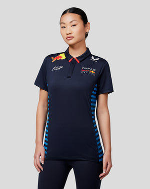 Woman in navy Max Verstappen Driver Polo with Oracle Red Bull Racing branding and red collar detail