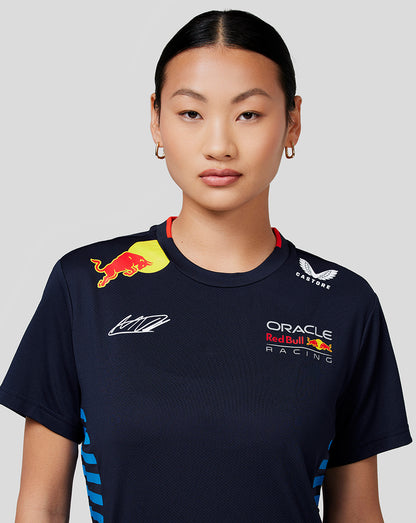 Full length view of a model wearing the navy Verstappen Teamline T shirt with blue side stripes, dark leggings and white sneakers