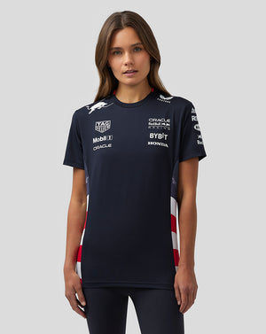 Front view of a woman wearing a navy America Race Team T Shirt with sponsor logos on the chest and red white checkered side panels