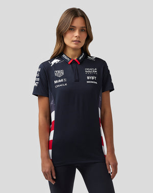 Women wearing a navy Oracle Red Bull Racing Teamline America polo in Night Sky with sponsor logos and striped side panels.