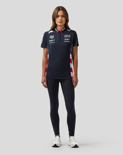 Model wearing navy Oracle Red Bull Racing Women’s America Race Team Polo with sponsor logos