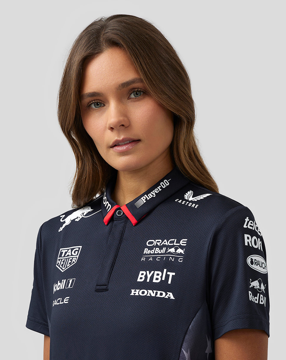 Female model wearing Oracle Red Bull Racing Women’s America Race Team Polo in night sky with team logos