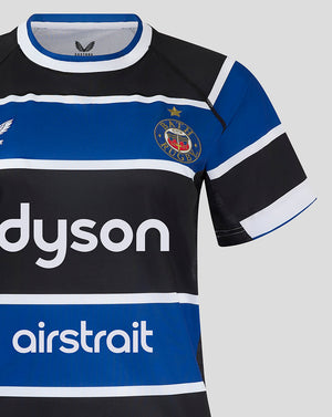 Close up of Bath Rugby jersey chest showing the club crest on the left and Dyson logo across the front.