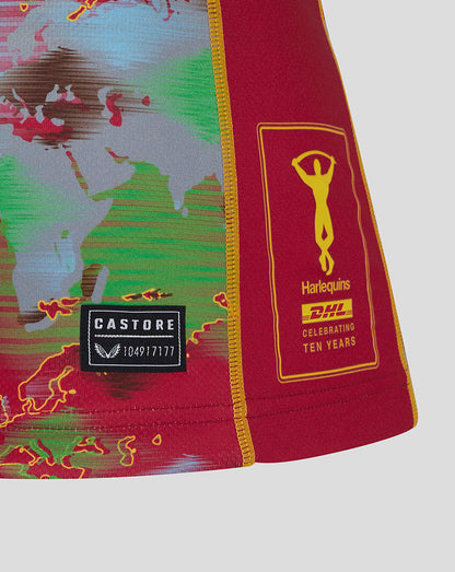 Sleeve close-up showing Harlequins crest and DHL patch with a Castore label at the hem.