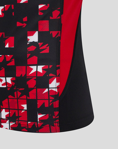 Side view of the black Saracens matchday tee showing red side panel and a bold red white mosaic pattern on the lower front