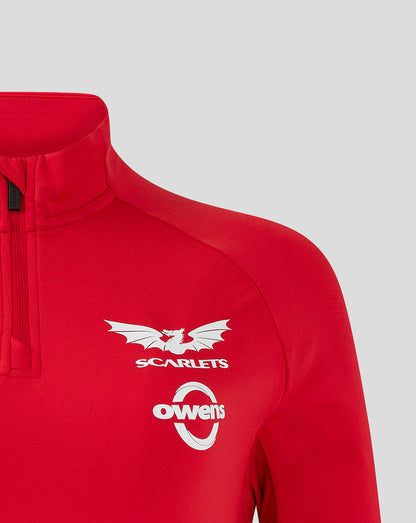 Close up of red Scarlets midlayer chest with Castore logo on left, Scarlets crest and Owens sponsor on right chest