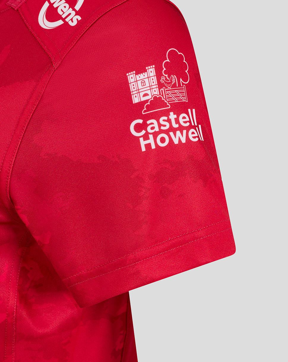 Scarlets home shirt sleeve close up featuring Castell Howell sponsor logo on red fabric