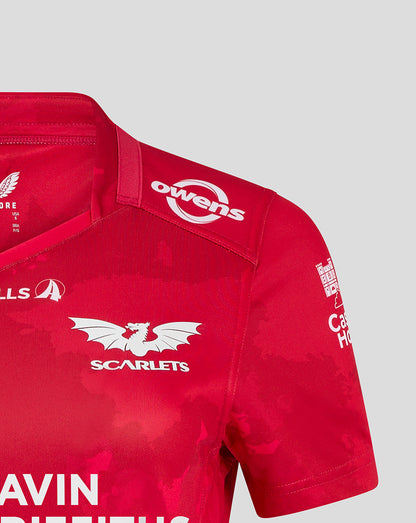 Close up of red Scarlets women's home shirt featuring the team crest and Castore branding on the shoulder.