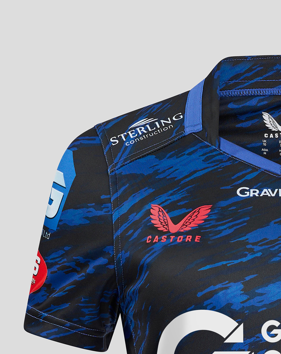 Shoulder detail of Scarlets Away Shirt with Sterling Construction patch, blue camouflage pattern, and Castore branding nearby.