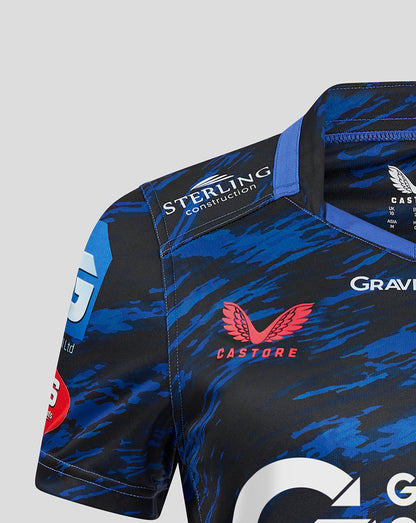 Shoulder detail of Scarlets Away Shirt with Sterling Construction patch, blue camouflage pattern, and Castore branding nearby.