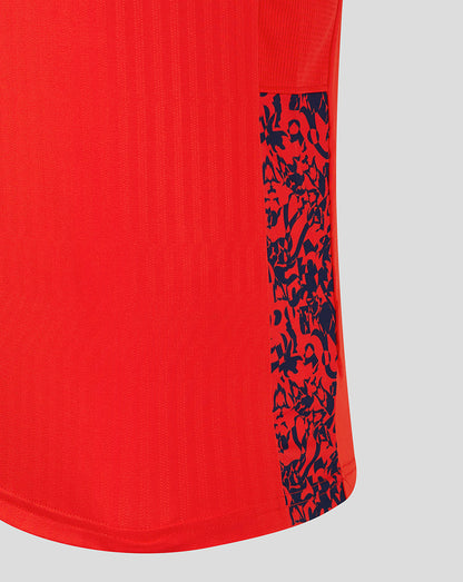 Lower side panel on the red England shirt with a navy abstract pattern.