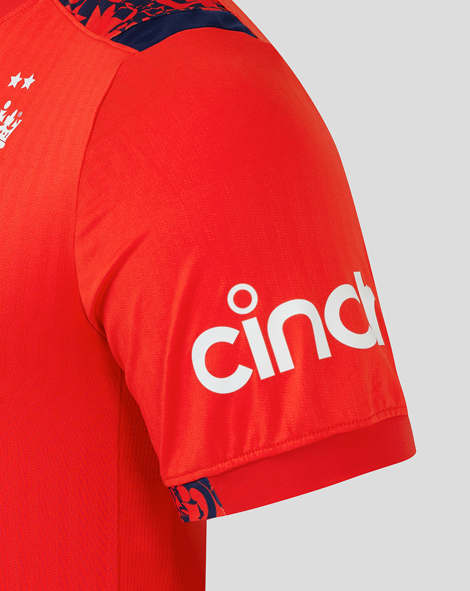 Shoulder and sleeve close-up of the red England shirt, featuring navy patterned trim along the shoulder.