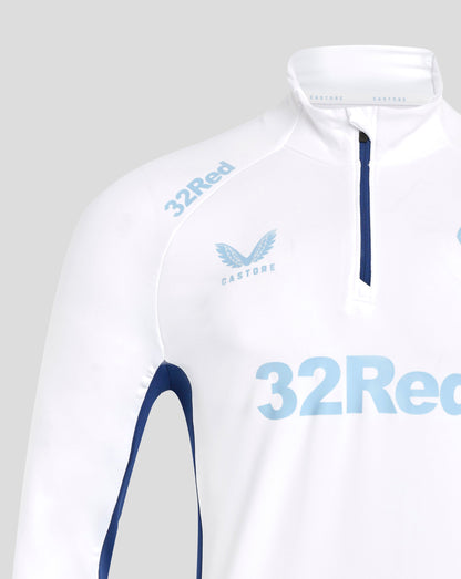 Front close up of white training top showing blue front zipper and light blue club crest on chest