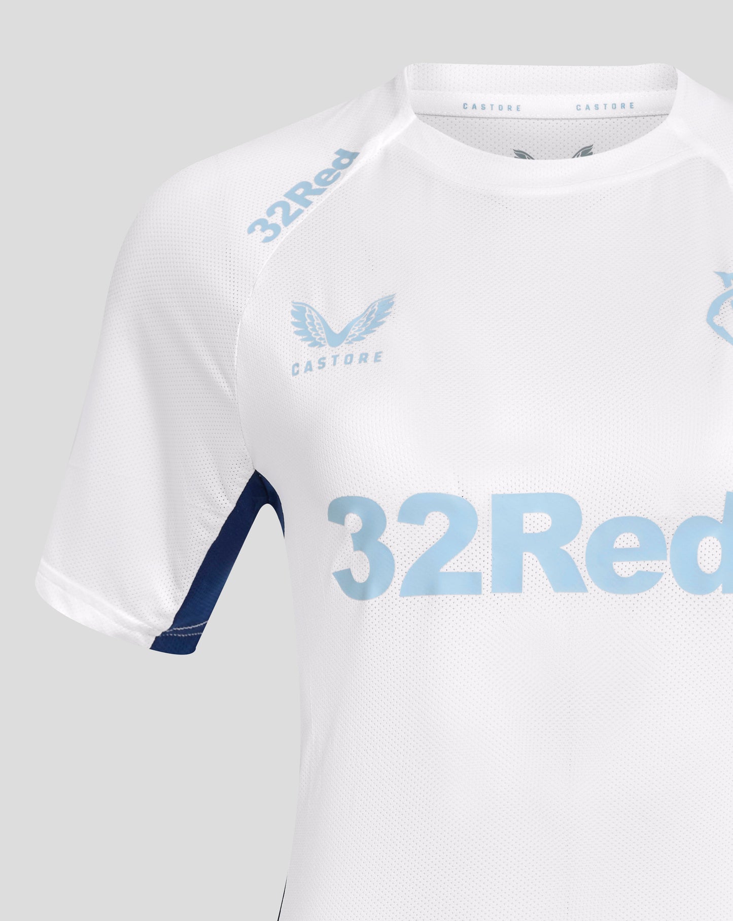 Close up of white Rangers training tee with light blue crest and 32Red across the chest and Castore branding on the collar