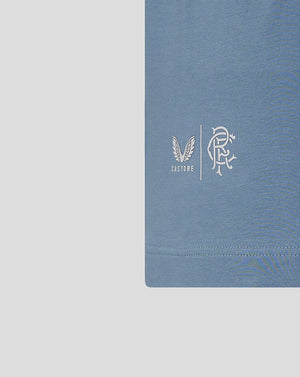 Close up of light blue Rangers travel T shirt chest showing Castore logo beside the club crest