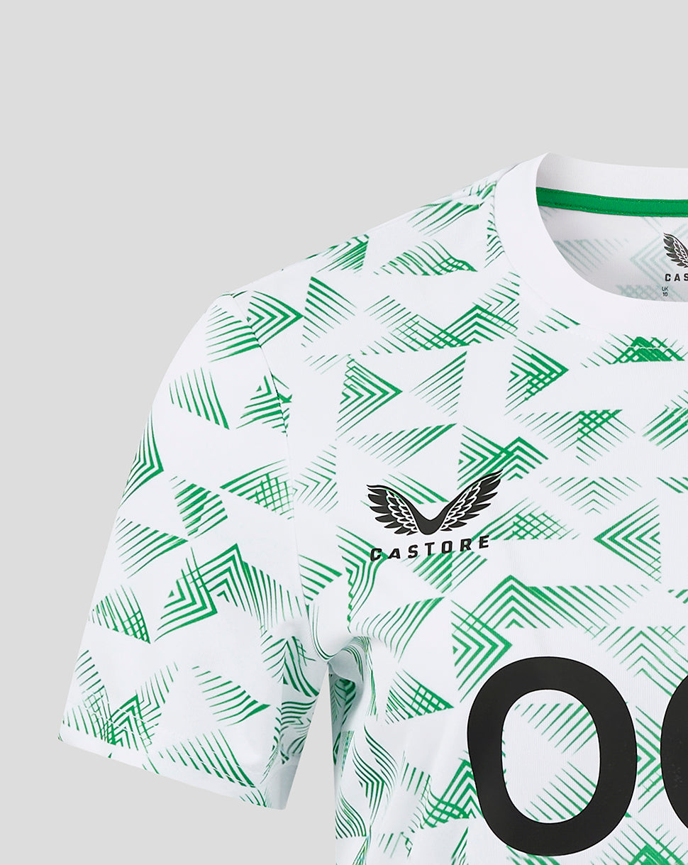 Close up of Mansfield Away Shirt showing crest on left chest amid geometric green print