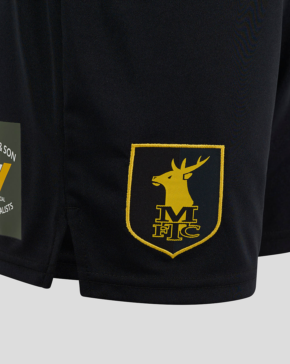 Close-up of Mansfield Third Shorts fabric with a raised yellow crest on the right thigh and Castore branding on the left.