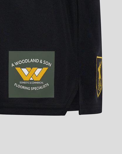 Lower leg of Mansfield Third Shorts featuring a green sponsor patch with white text and a yellow logo.