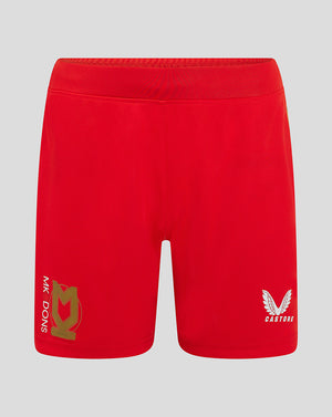 Front view of red Mk Dons women's 24/25 away shorts with crest on left leg and Castore logo on right.