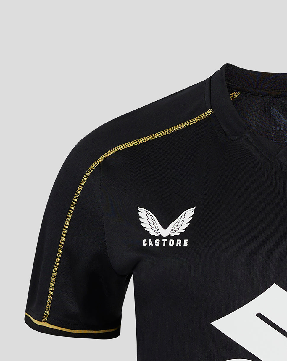 Black Mk Dons women's 24/25 third shirt with gold piping along the shoulder and a white winged crest under Castore branding