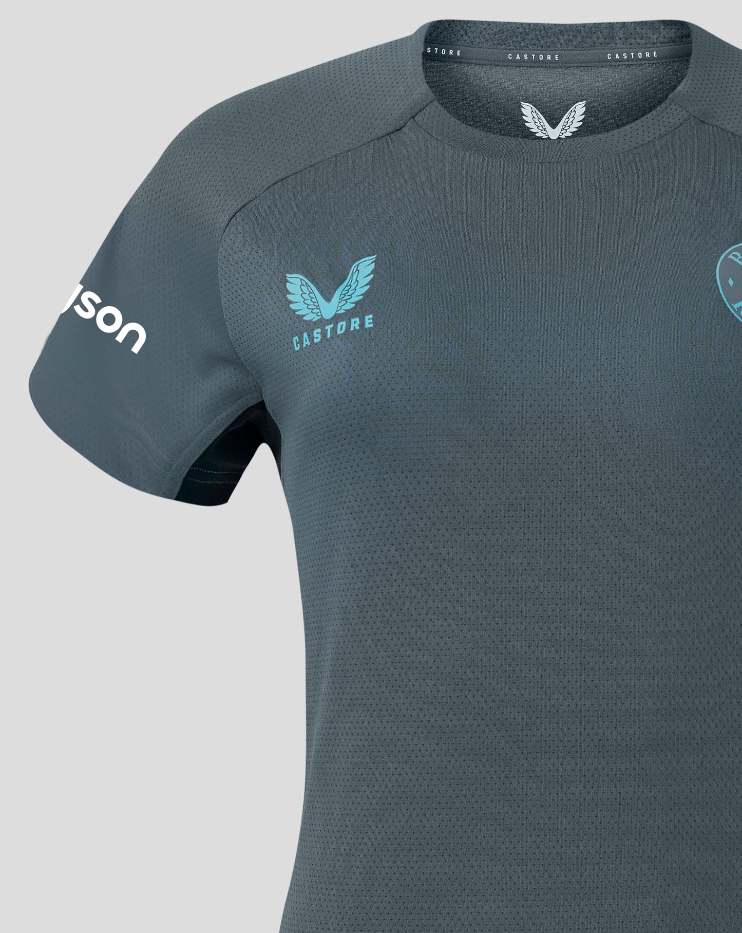Bath Rugby training shirt close up showing turquoise Castore logo on left chest and Bath Rugby crest on right chest