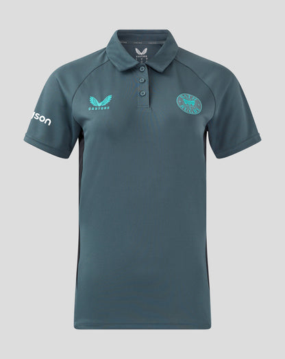 Front view of Bath Rugby women's Rise Pro polo in teal, with Castore wing logo on the left chest and Bath Rugby crest on the right chest.