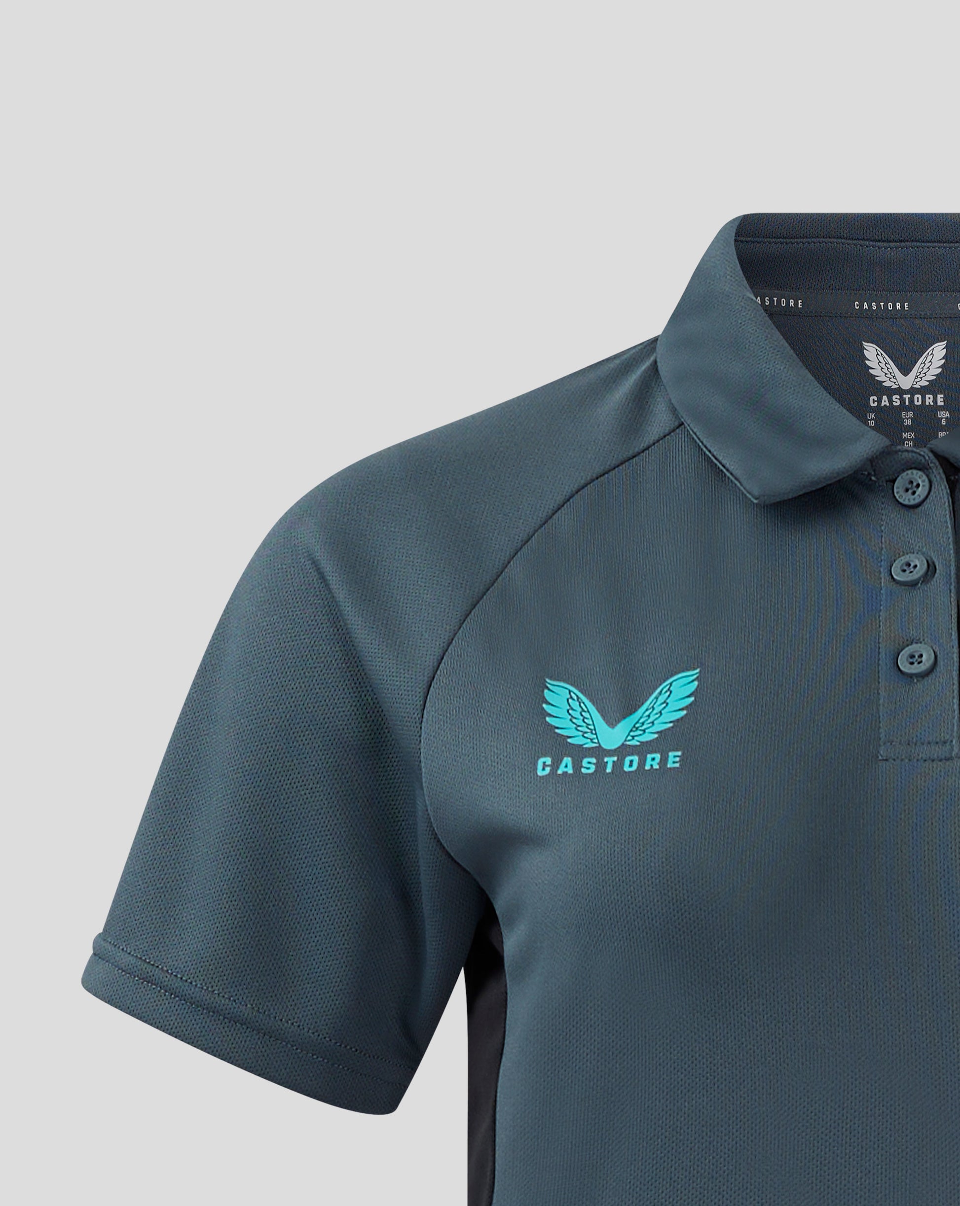 Close up of Bath Rugby women's polo collar and chest area showing teal wing crest.