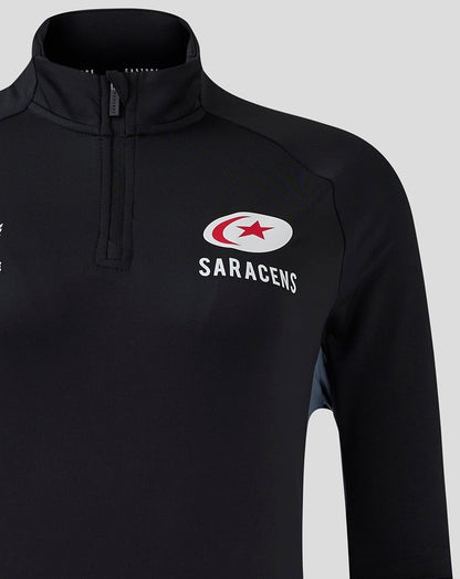 Close-up of the chest area on black Saracens training top showing the quarter-zip placket and logo