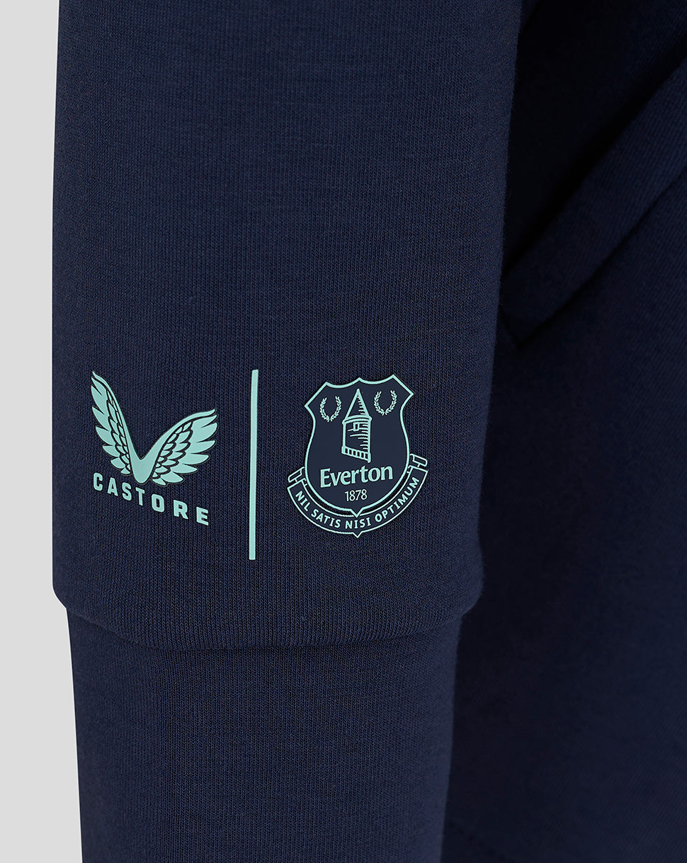 Close-up of navy fabric featuring light blue Castore logo and Everton crest on the sleeve
