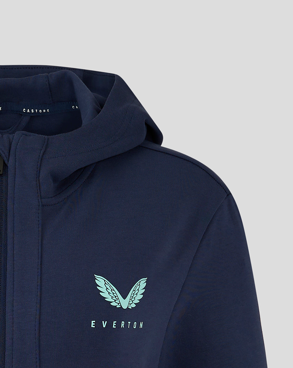 Close-up of left chest logo featuring a light blue wing emblem and Everton text on navy jacket