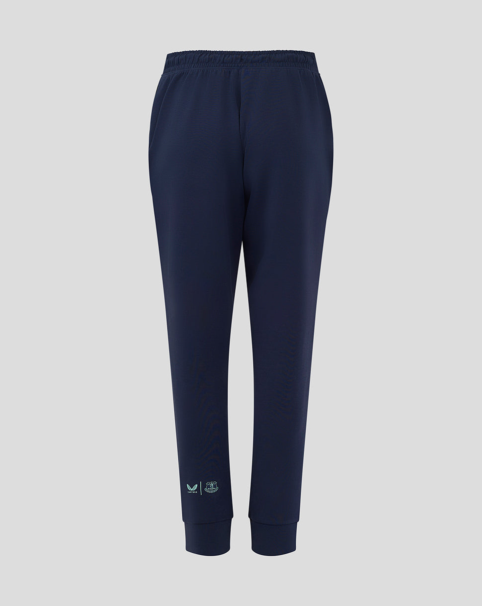 Back view of navy Everton travel pants with an elastic waistband and ribbed cuffs and mint logos near the ankle