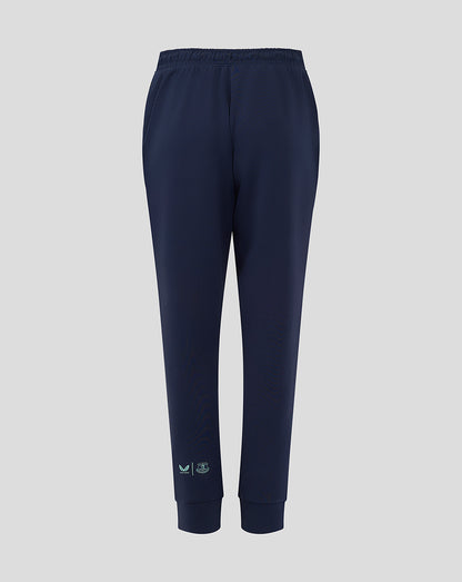 Back view of navy Everton travel pants with an elastic waistband and ribbed cuffs and mint logos near the ankle